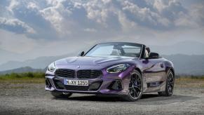 A BMW Z4 M40i performance-focused sports car coupe model parked on a gravel/sand plain