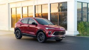 The 2024 Buick Encore GX Sport Touring subcompact SUV model in Cinnabar Metallic