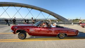 Kevin de León in a 1960s-era Chevy Impala custom lowrider model crossing 6th Street Bridge in Los Angeles