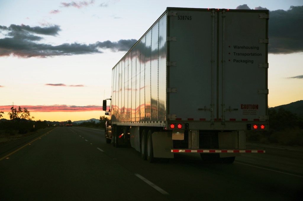 18-wheeler semi-truck driving down the highway.