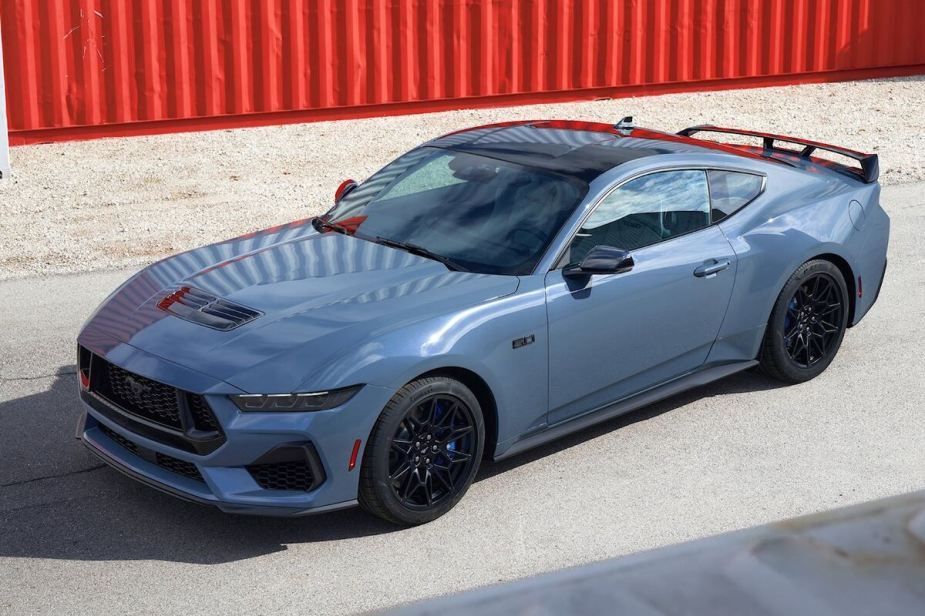 2024 Ford Mustang S650 parked next to shipping containers