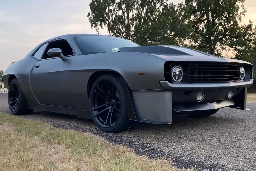1969 Camaro/late model Challenger mashup sitting on rocky path