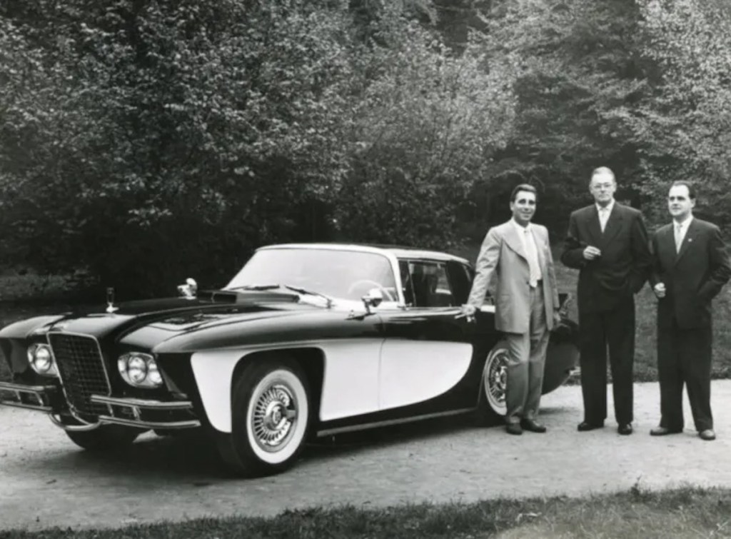 The Gaylord brothers and a Zeppelin employee stand next to a prototype of their 1957 Gladiator supercar.