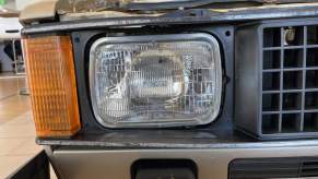 The headlight of a VW Rabbit pickup truck on the Cars & Bids website.