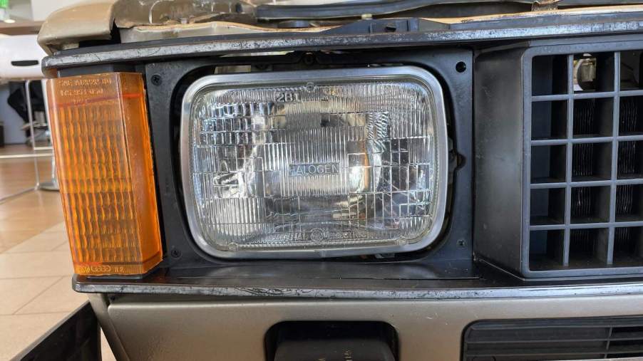 The headlight of a VW Rabbit pickup truck on the Cars & Bids website.