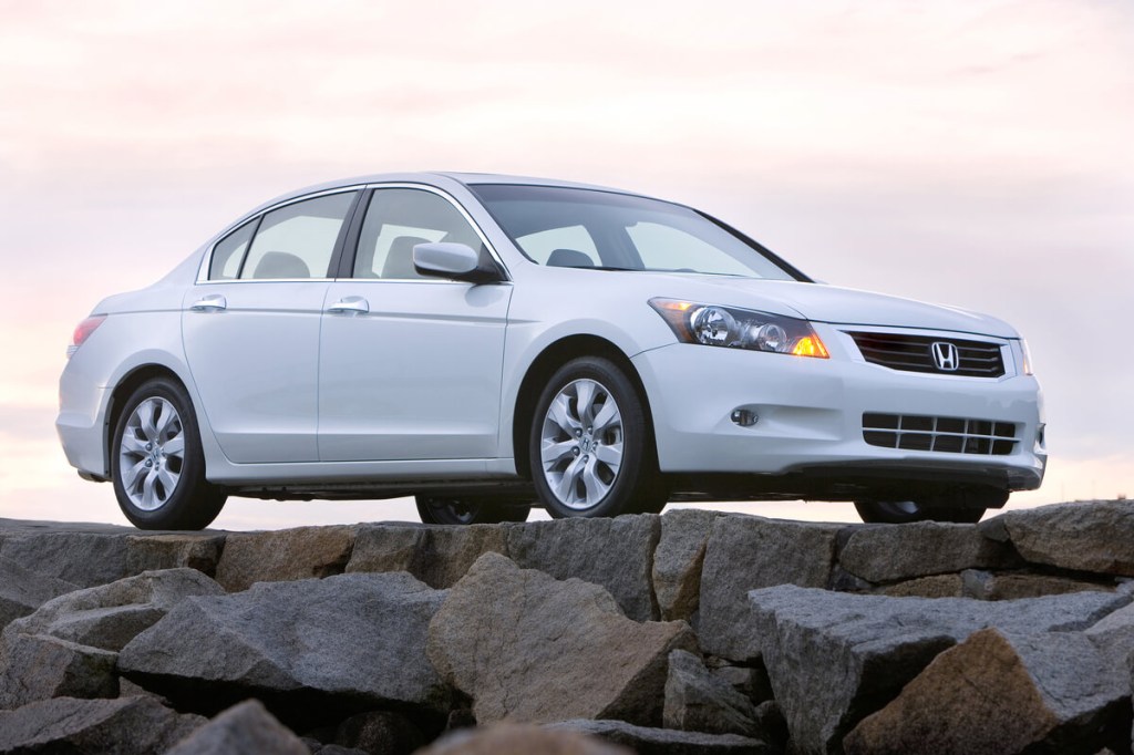 A white 2008 honda accord V6 sedan on the rocks