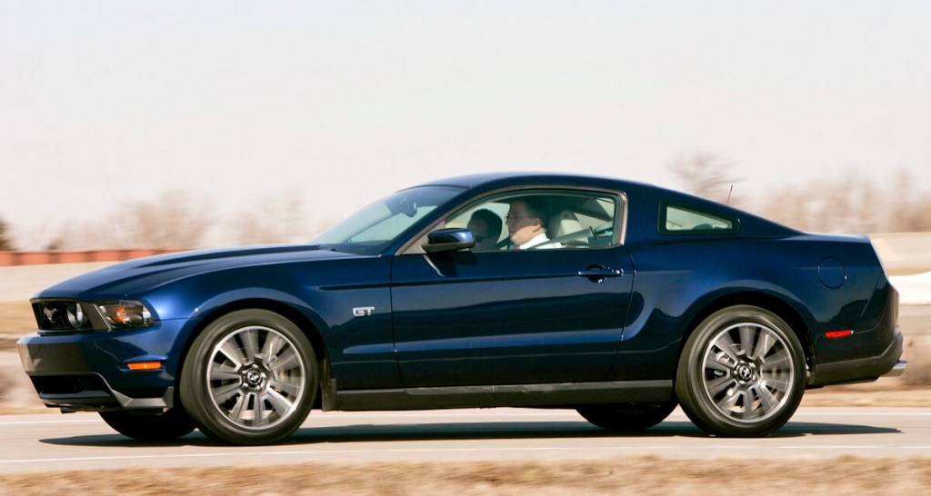 A blue 2010 Ford Mustang GT shows off its side profile.
