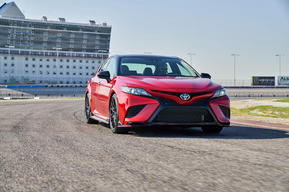 A red 2023 Toyota Camry TRD on a racetrack.