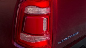 The tail light of a red Ram 1500 Limited pickup truck.