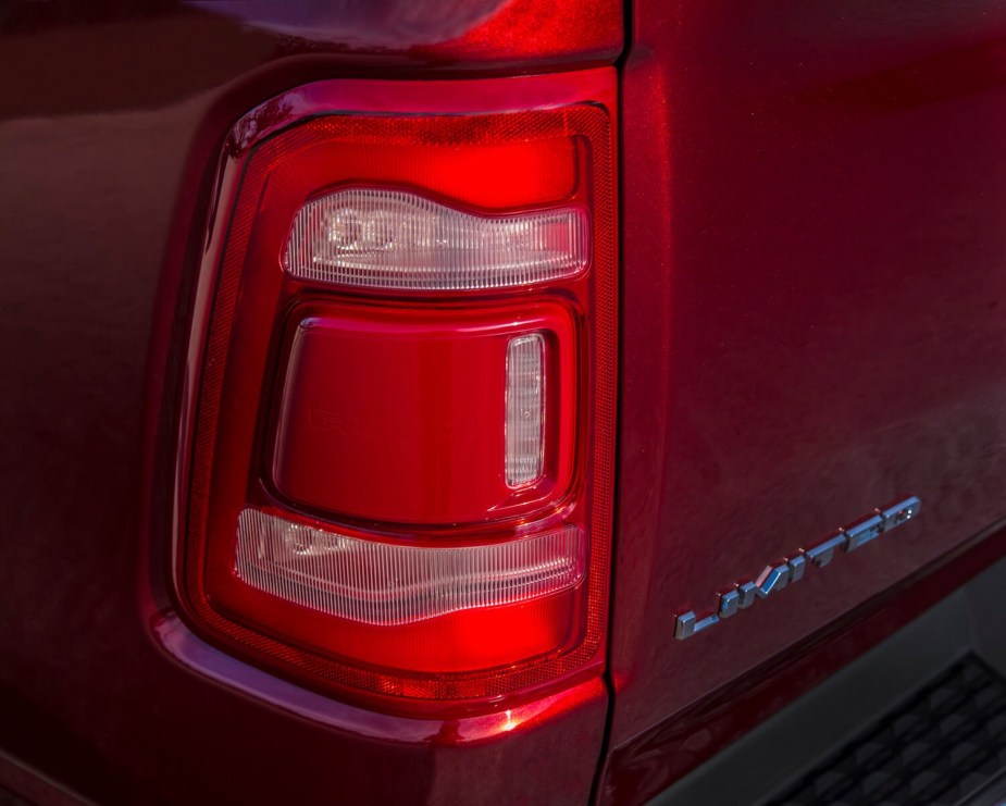 The tail light of a red Ram 1500 Limited pickup truck.