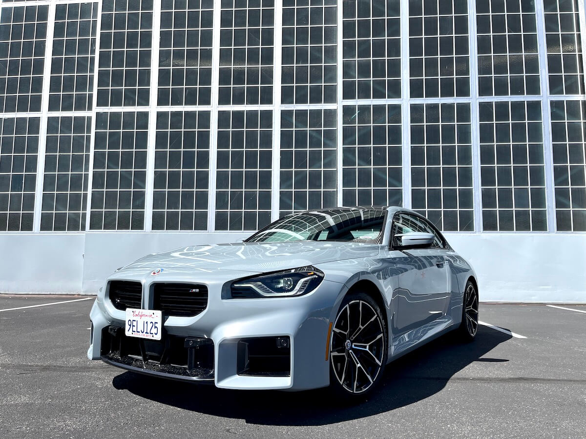 A front view of the 2023 BMW M2 in front of a building