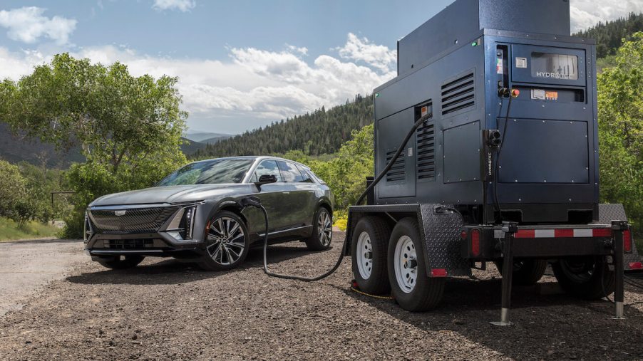 A gray 2023 Cadillac Lyriq charging with a mobile generator. While not necessarily a top contender, the Cadillac Lyriq value shouldn't be underestimated.