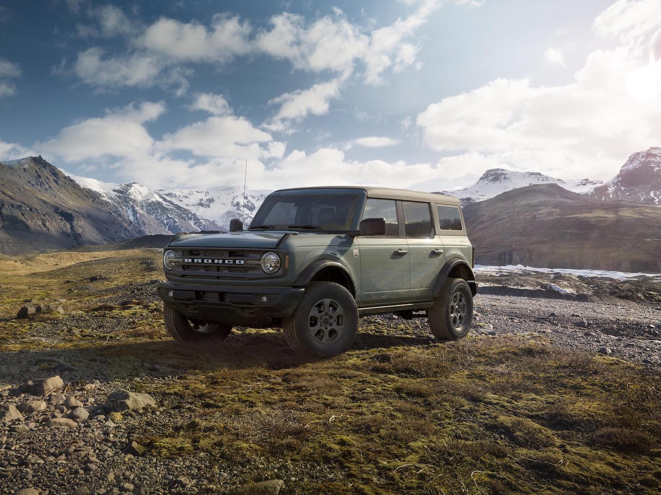 A green 2023 Ford Bronco parked in front of mountains. Bronco sales aren't where they should be.