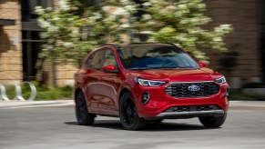 2023 Ford Escape in red driving in the city. Ford Escape owners would like to see some changes.