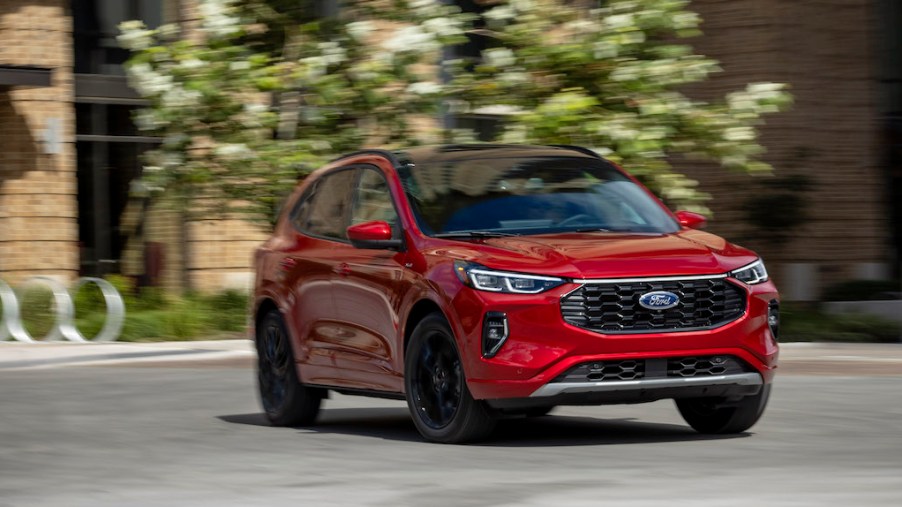 2023 Ford Escape in red driving in the city. Ford Escape owners would like to see some changes.