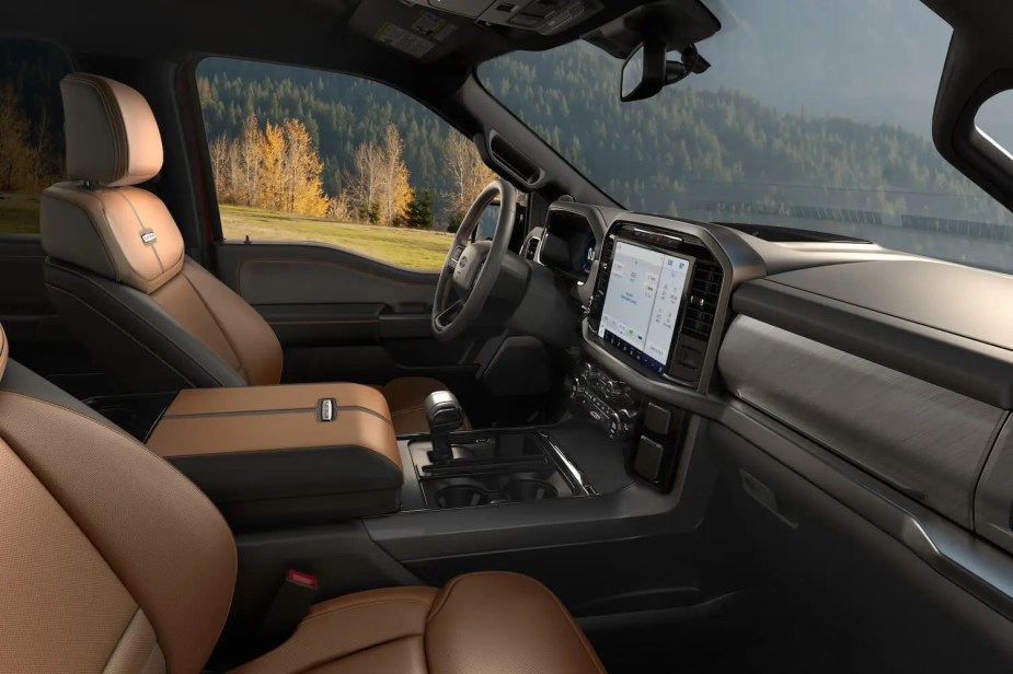 The brown leather and wood trim interior of a top-trim "King Ranch" Ford F-150.