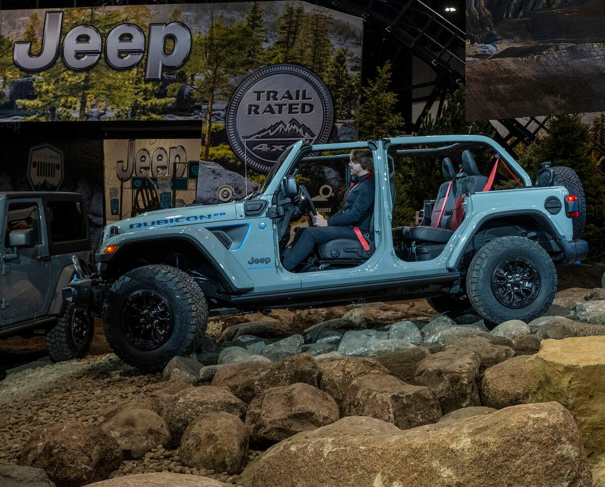 A blue 2023 Jeep Wrangler 4xe Rubicon 20th Anniversary Edition with the doors and roof off