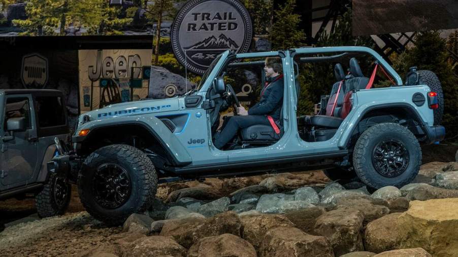 A blue 2023 Jeep Wrangler 4xe Rubicon 20th Anniversary Edition with the doors and roof off