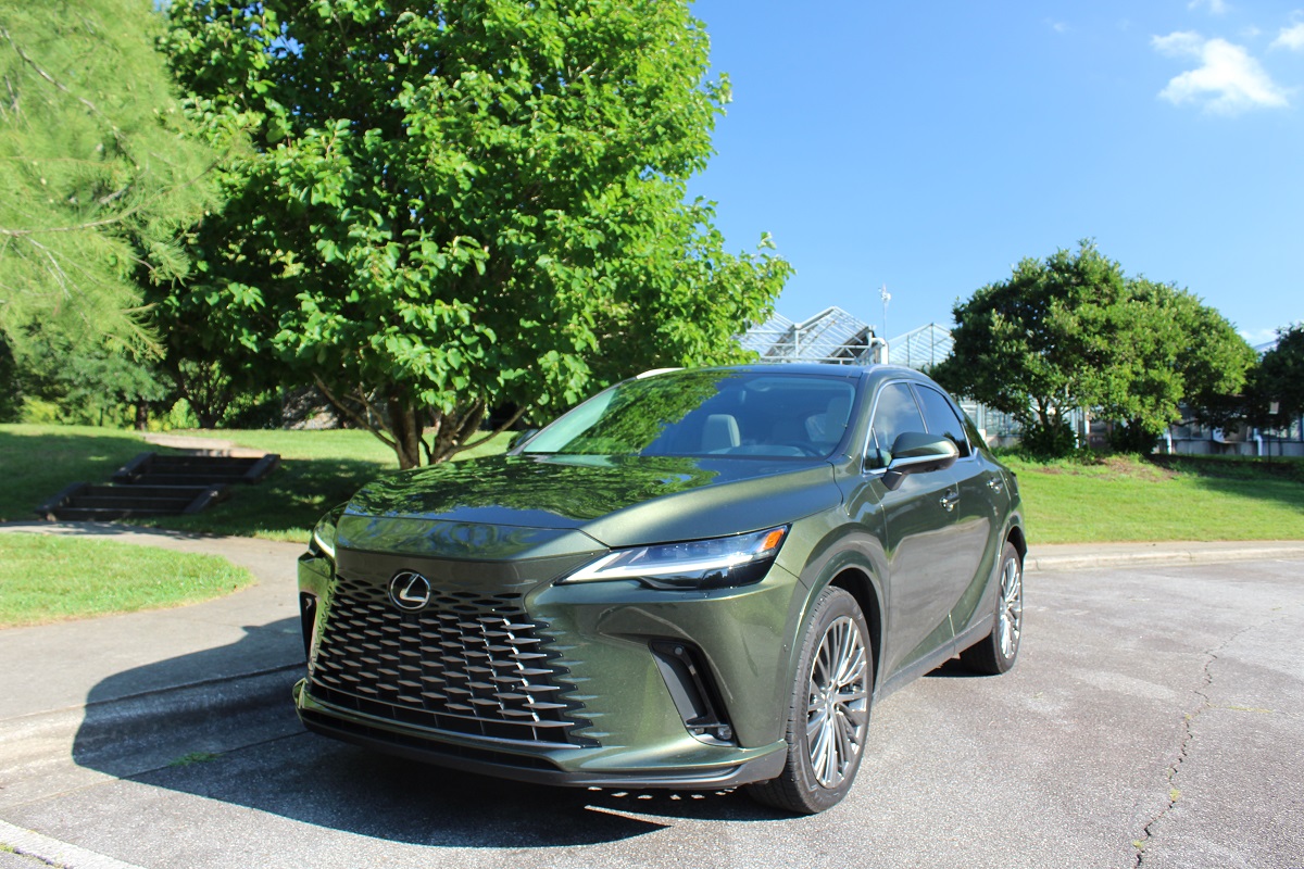 The 2023 Lexus RX 350h parked near green trees