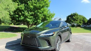 The 2023 Lexus RX 350h parked near green trees