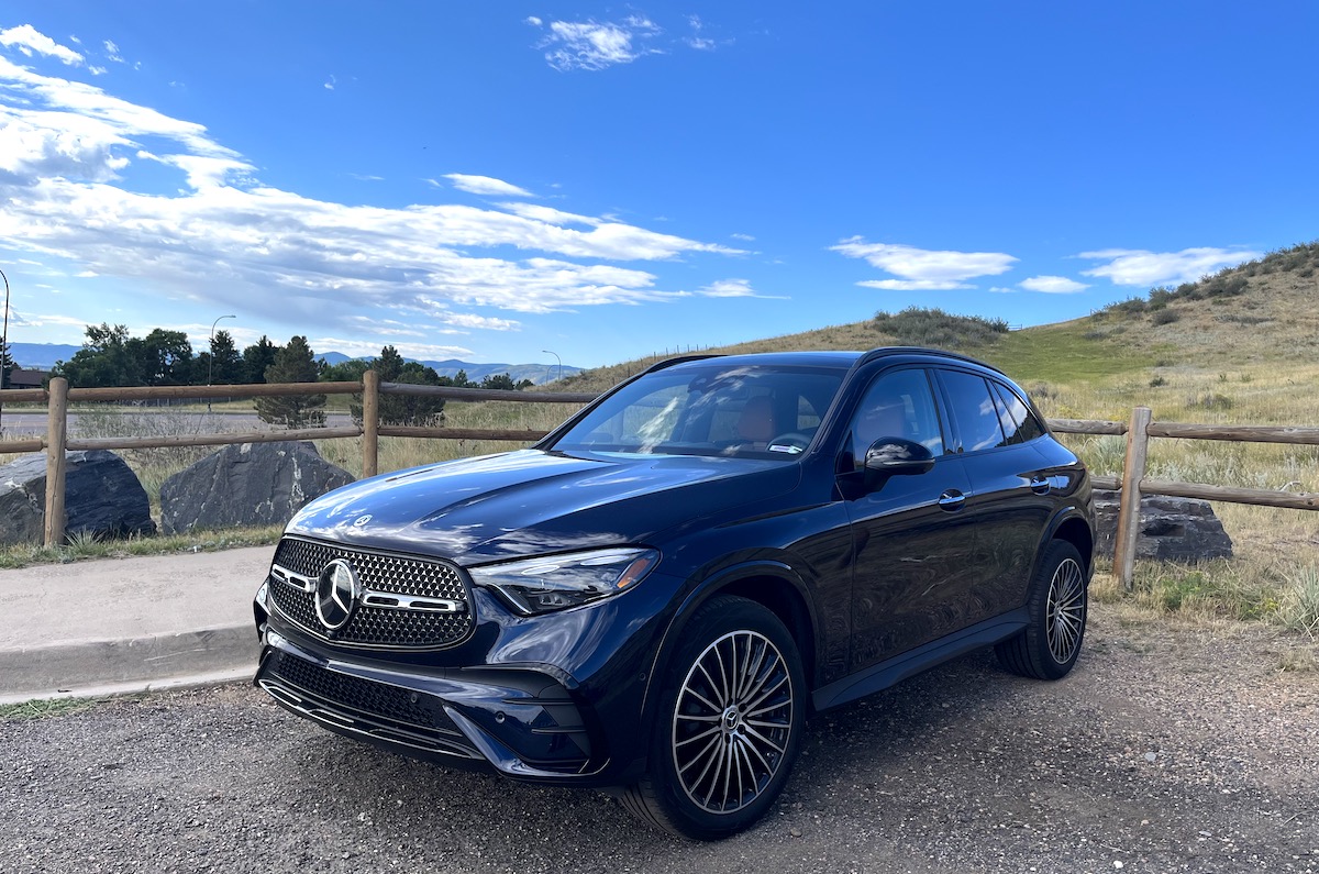 A front corner view of the 2023 Mercedes-Benz GLC 300 by a mountain