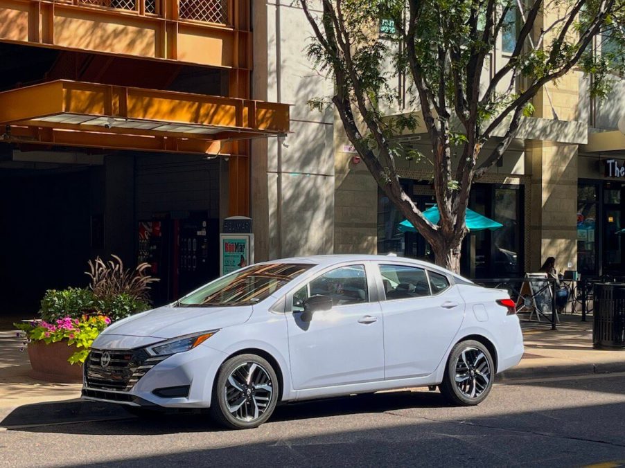 A front view of the 2023 Nissan Versa parked on a city block