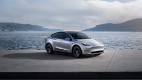 A gray 2023 Tesla Model Y small electric SUV is parked.