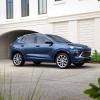 The 2024 Buick Encore GX Avenir subcompact SUV model parked on a driveway plaza