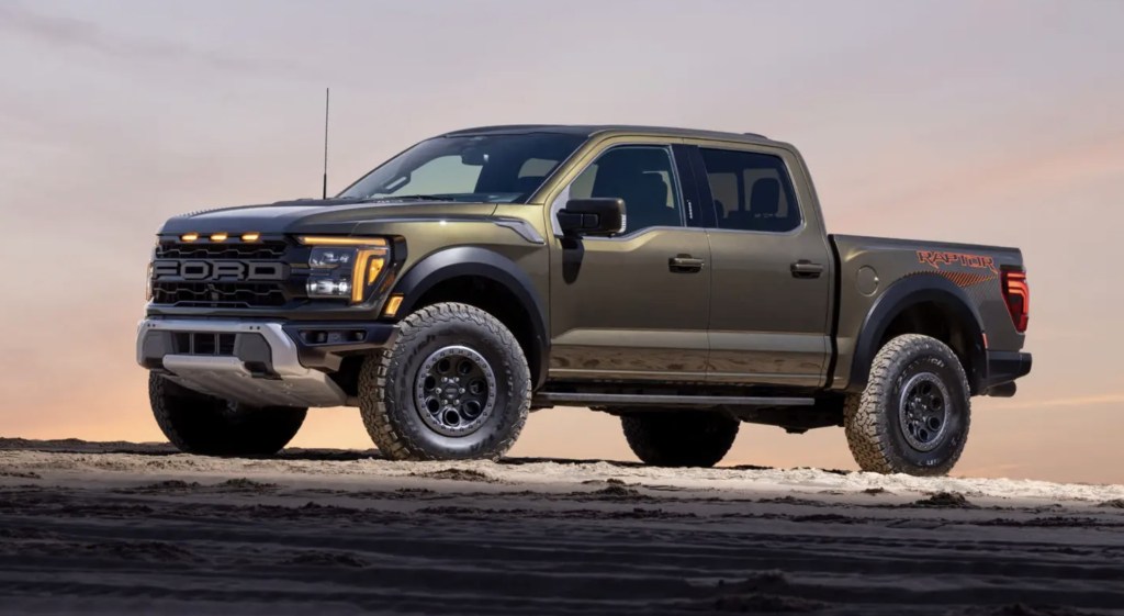 The 2024 Ford F-150 Raptor off-roading at dusk