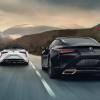 A pair of Lexus LC 500s driving down a road