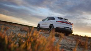 A white 2024 Porsche Cayenne parked on a plain field. The Cayenne recall affects 3,000 2024 models.
