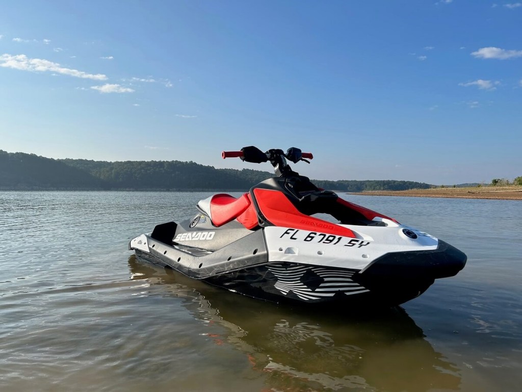 A red and white 2024 Sea-Doo SPARK TRIXX jet ski sits on Beaver Lake.