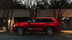 A red 2024 Toyota Sequoia at dusk. The 2024 Toyota Sequoia price can get pretty high up there.