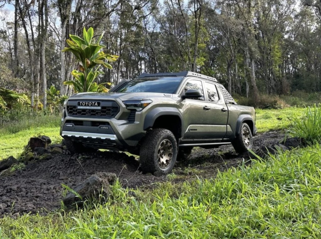 The 2024 Toyota Tacoma Trailhunter driving over mud 