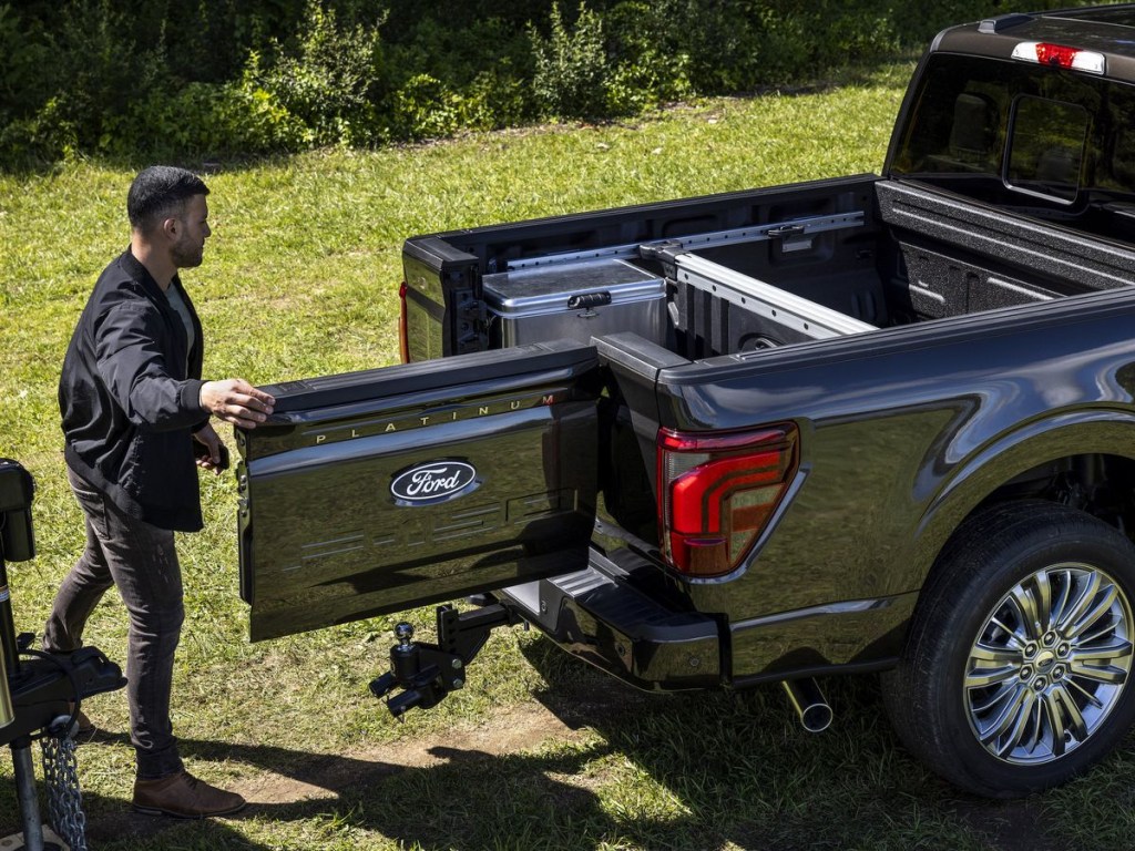 A person opening the 2024 Ford F-150 Pro Access Tailgate