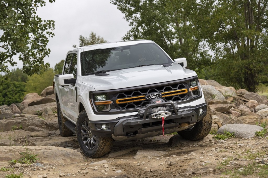 The 2024 Ford F-150 Tremor off-roading over rocks