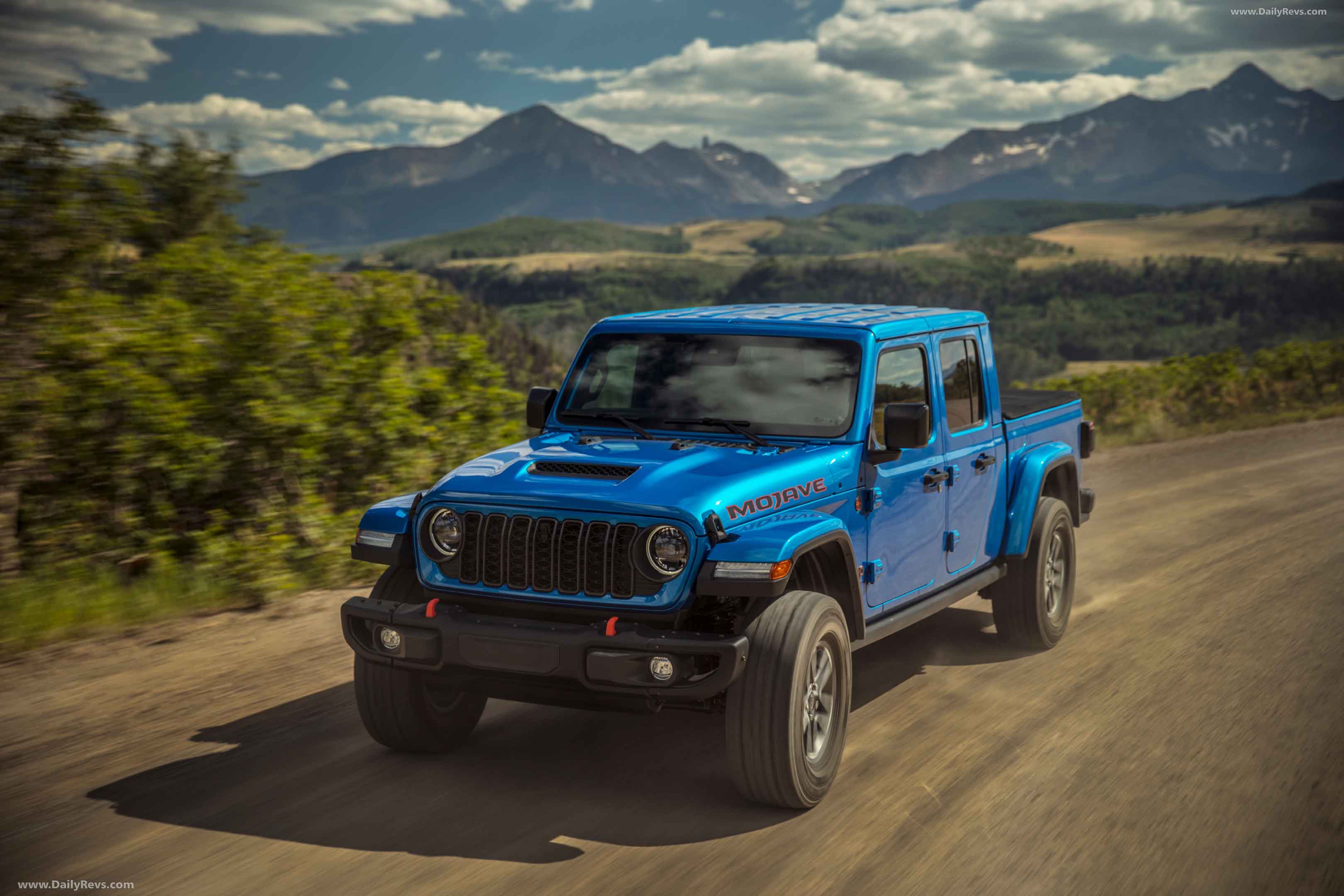 the 2024 Jeep Gladiator driving on a dirt road
