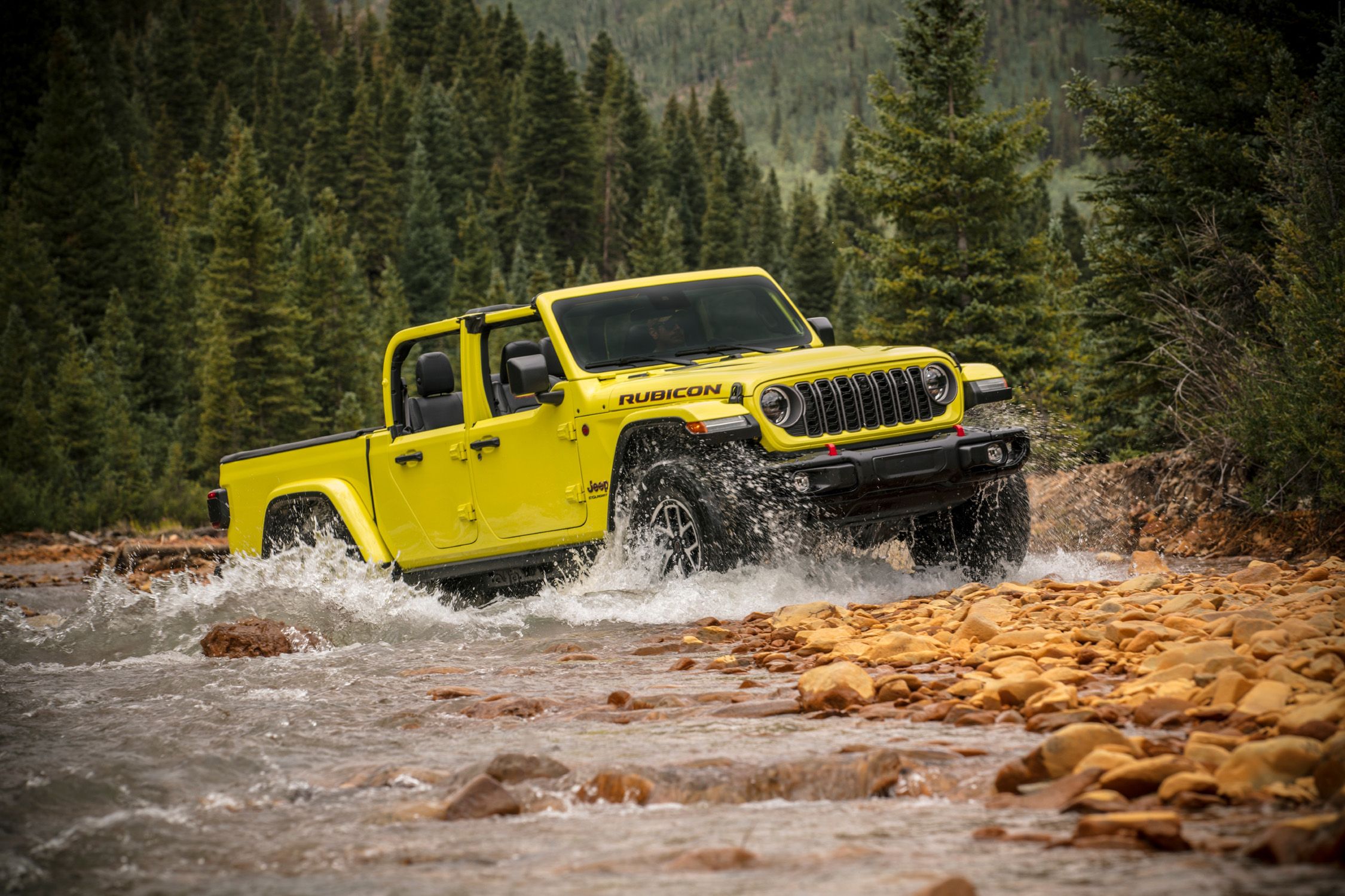 The 2024 Jeep Gladiator Rubicon X off-roading through a river