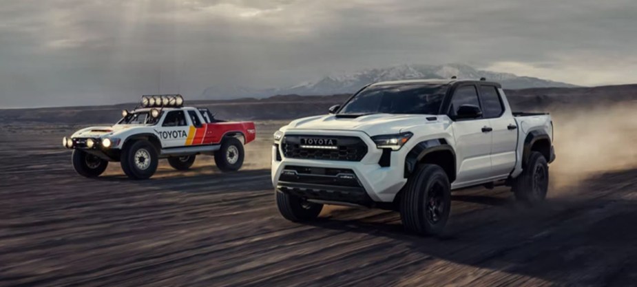 Two Toyota Tacoma models racing across the desert 