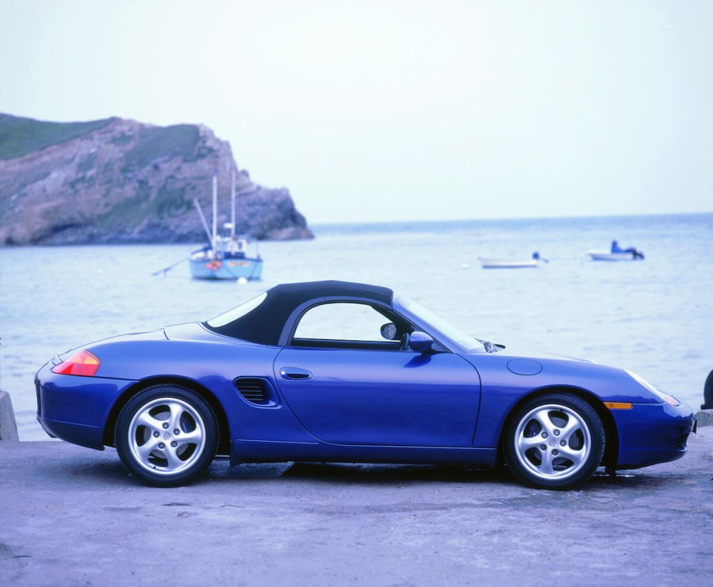 A side view of a blue 986 Porsche Boxster
