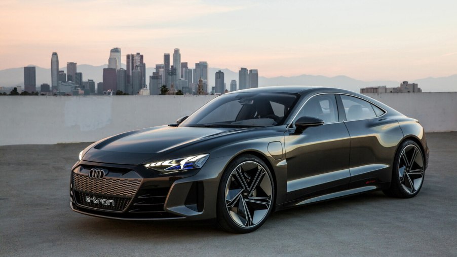 2023 Audi e-Tron EV by river with city in background