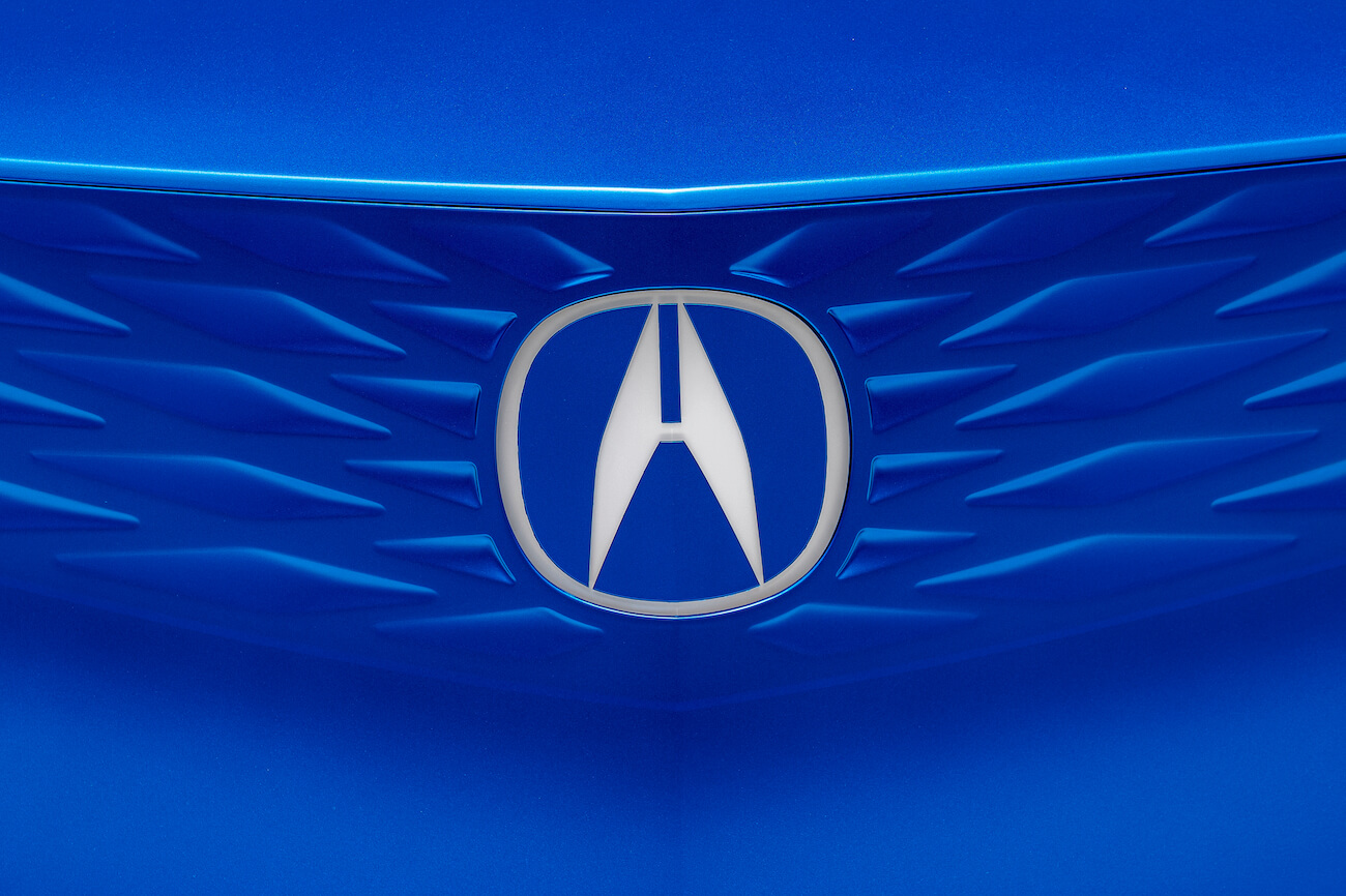 The blue front grille of a vehicle with Acura Super Handling.