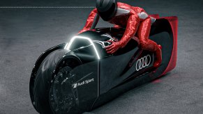 Audi Robosphere EV motorcycle concept with rider in studio shot