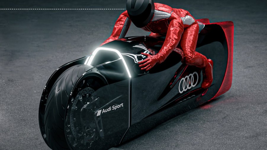Audi Robosphere EV motorcycle concept with rider in studio shot