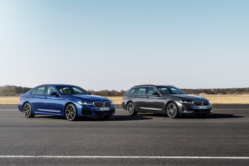 A set of BMW AWD luxury cars park on the tarmac.