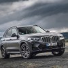 A black 2023 BMW X3 parked on a stormy day. The X3 is one of a few affordable luxury compact SUV options.