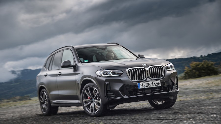 A black 2023 BMW X3 parked on a stormy day. The X3 is one of a few affordable luxury compact SUV options.