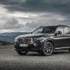 A BMW X3 xDrive30d compact luxury SUV model parked on a gravel plain under darkening clouds