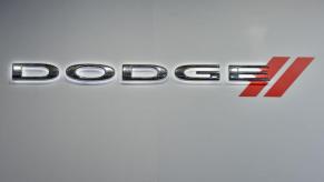 A Dodge logo on the side of a wall at an auto show.