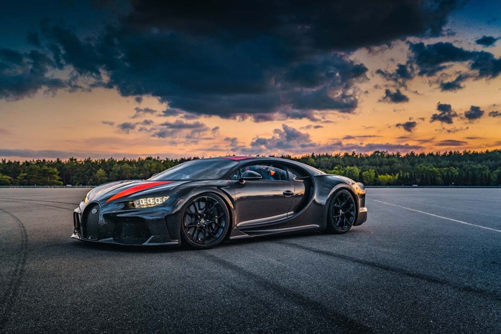 Bugatti Chiron Super Sport 300+, the fastest production car in the world, sitting on a runway with a beautiful sunset sky in the background